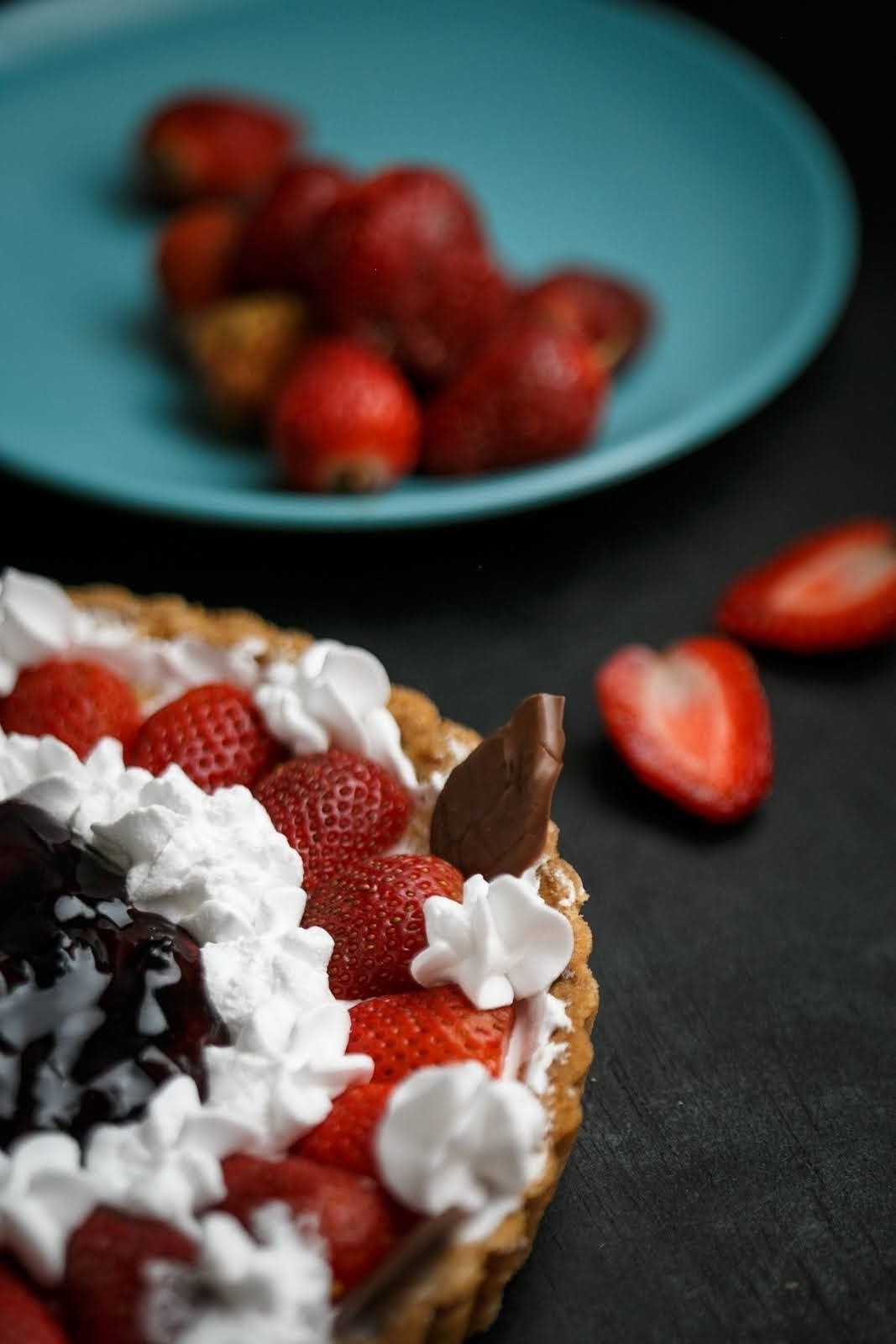Strawberry dessert with whipped cream and chocolate topping